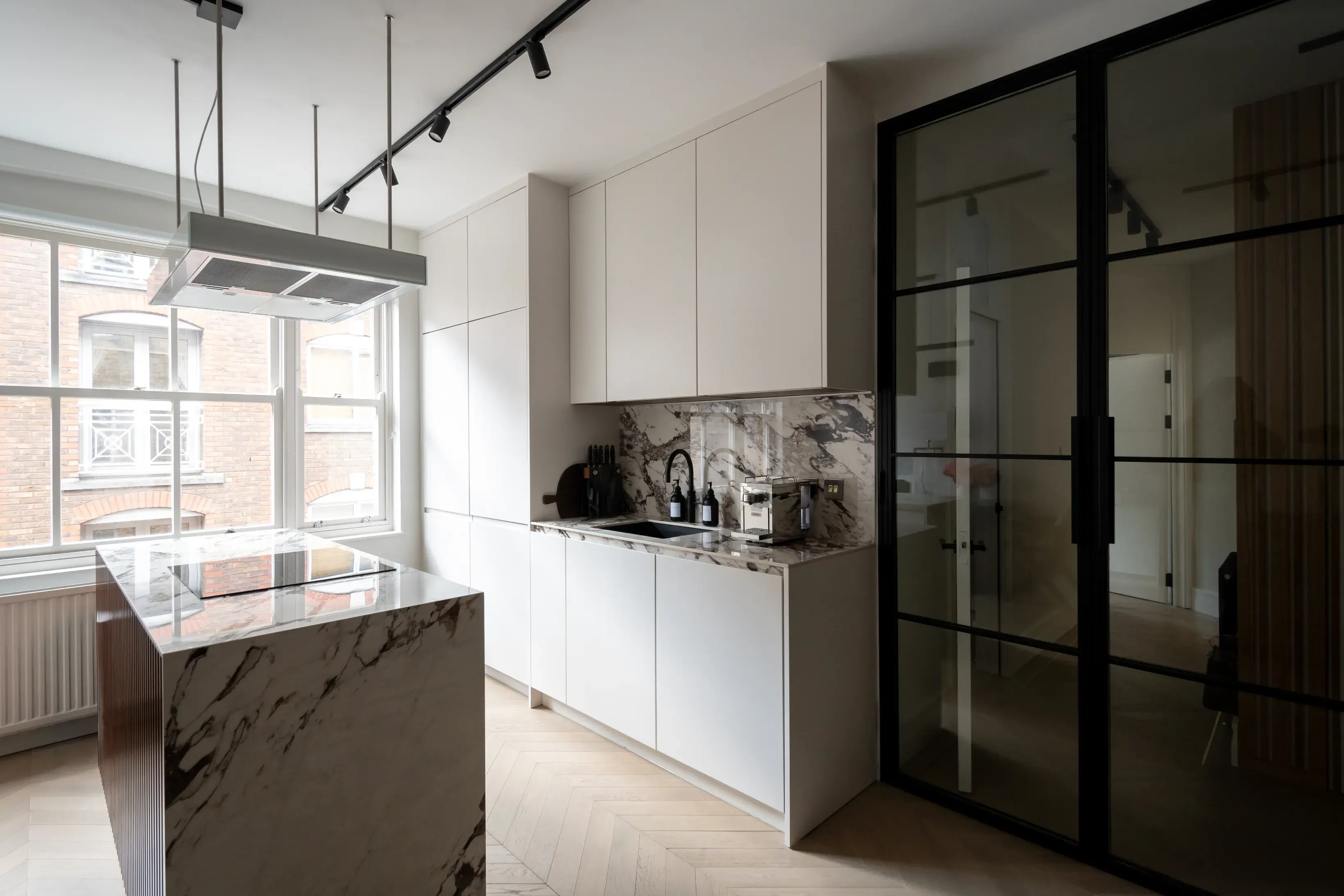 Floral Street Apartment kitchen with marble splashback and steel-framed glazed doors, Covent Garden