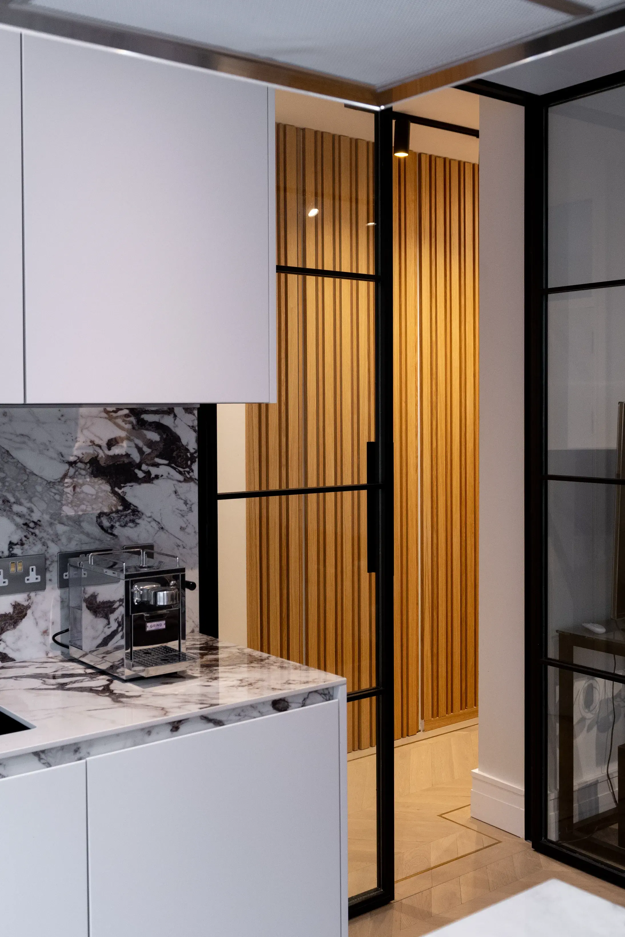 Fluted timber panel and steel-framed glazed door detail, Floral Street Apartment