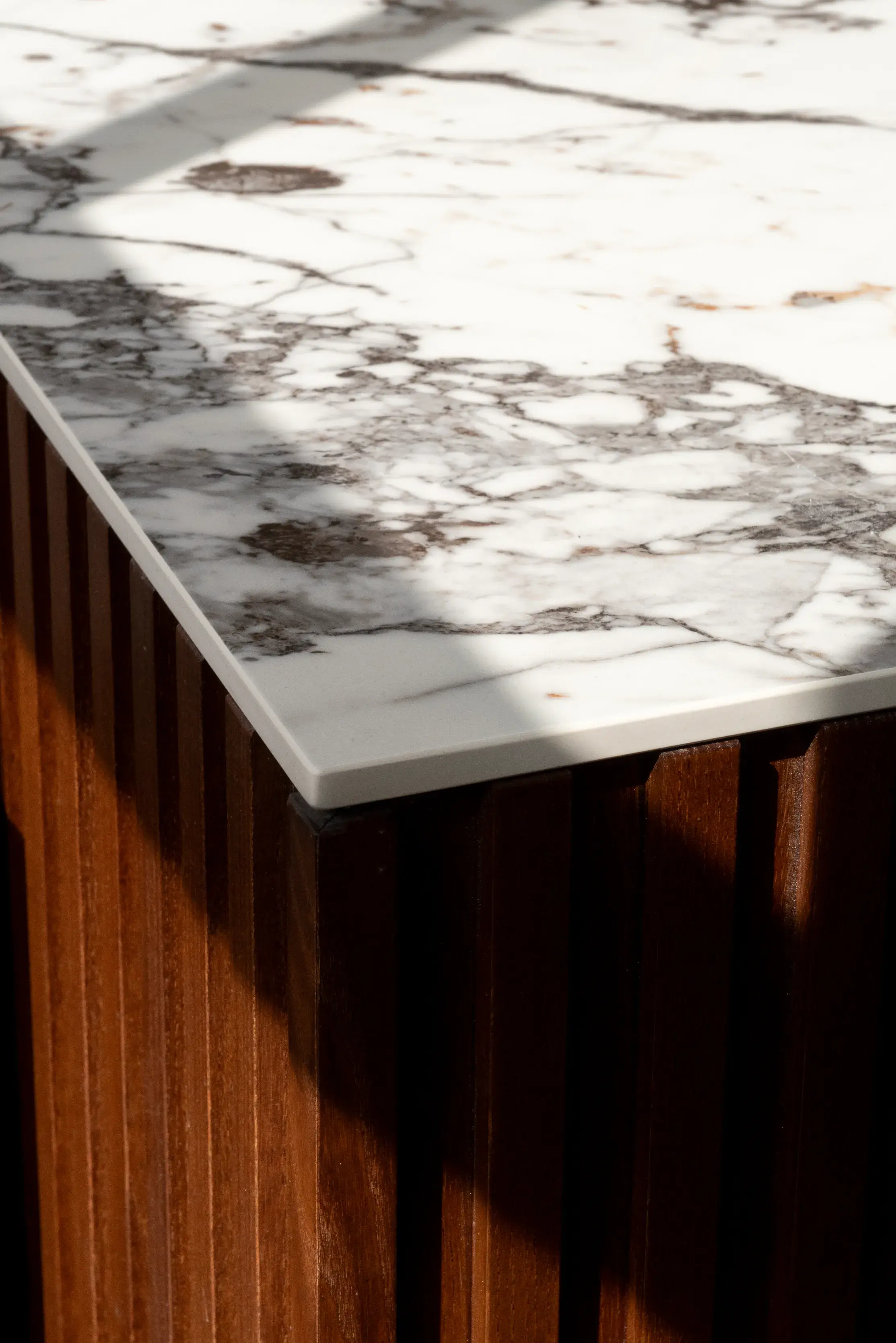 Marble worktop meeting fluted walnut panelling, Floral Street Apartment