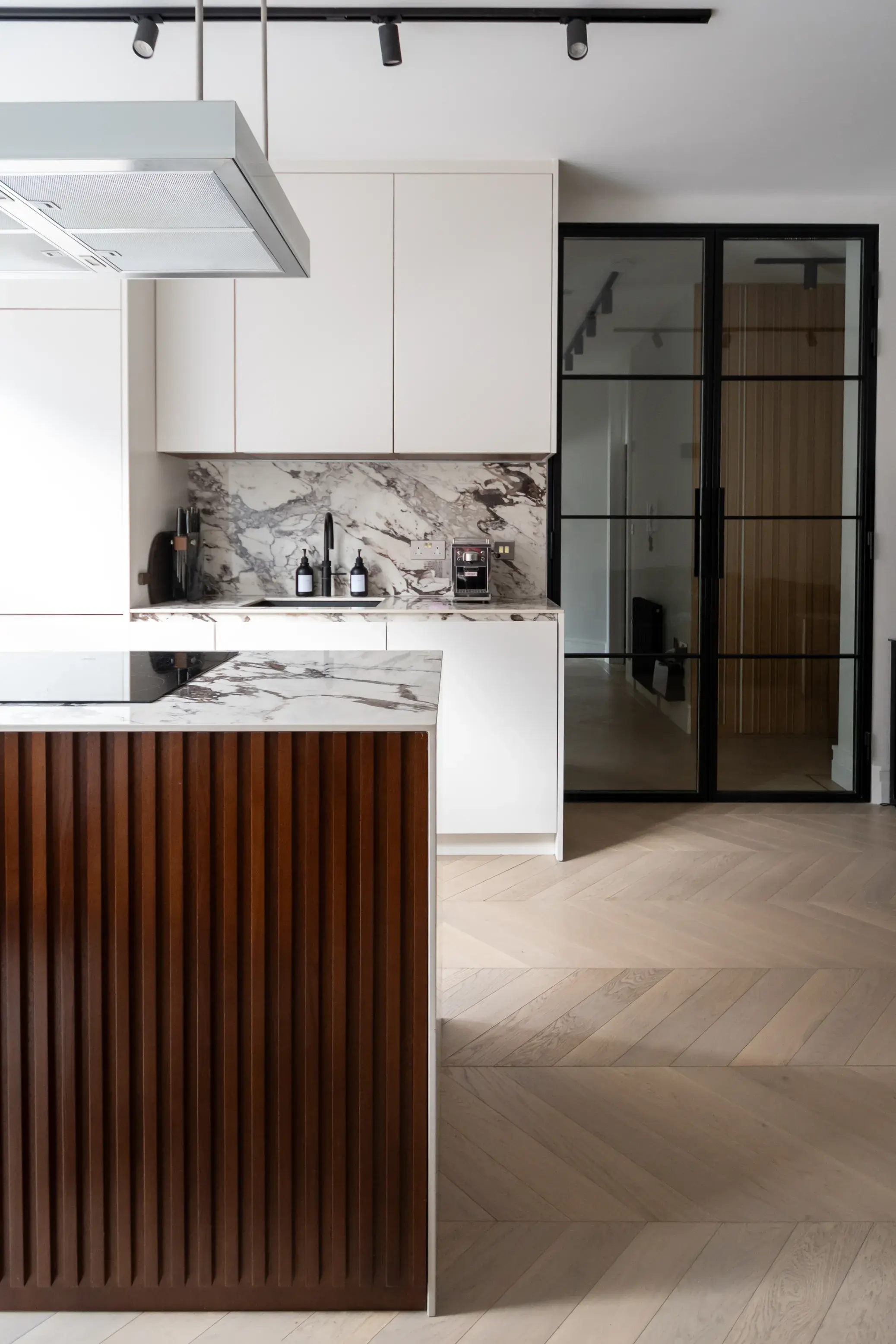 Kitchen island with fluted timber panelling and marble worktop, Floral Street Apartment